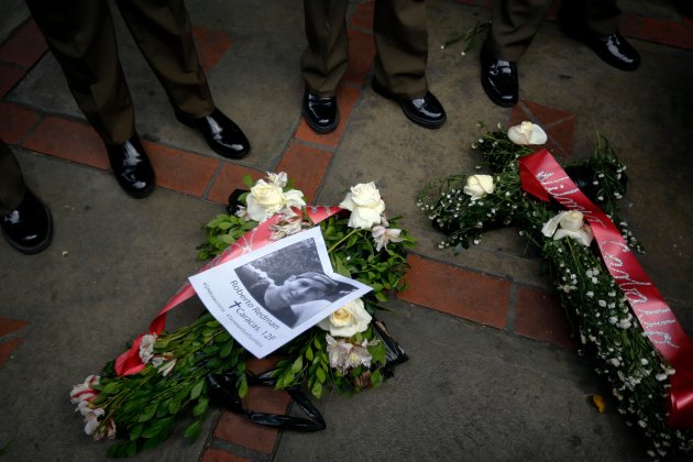 Flowers with the names of the victims of recent violence are laid by opposition demonstrators at the foot of national guards during a rally in Caracas