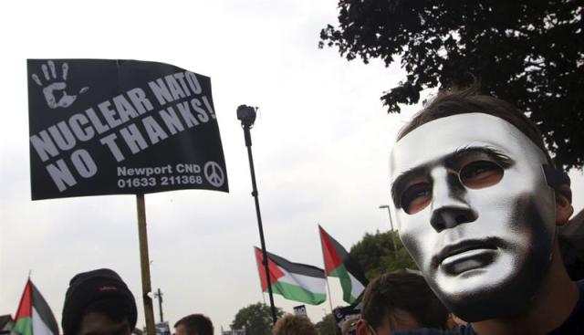 Manifestantes participan en una marcha hacia el hotel Celtic Manor, para mostrar su rechazo por la celebración de la cumbre bianual de la OTAN en Newport. EFE