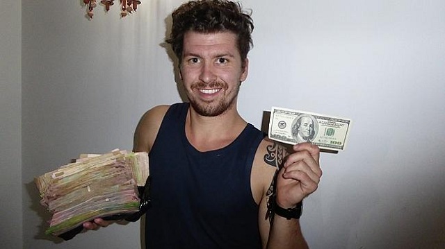 El mochilero Will Hatton con una "paca" de bolívares en efectivo / Foto Will Hatton