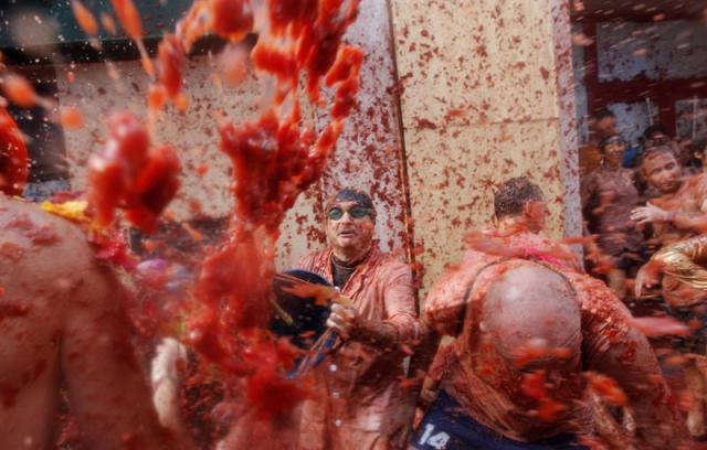 Vista general de la Tomatina en la calle principal de la localidad valenciana de Buñol que celebra el 70 aniversario de su tradicional fiesta, en la que participan más de 22.000 personas de 96 nacionalidades diferentes y en la que se lanzarán 150 toneladas de tomate, una cifra récord. EFE/Kai Försterling