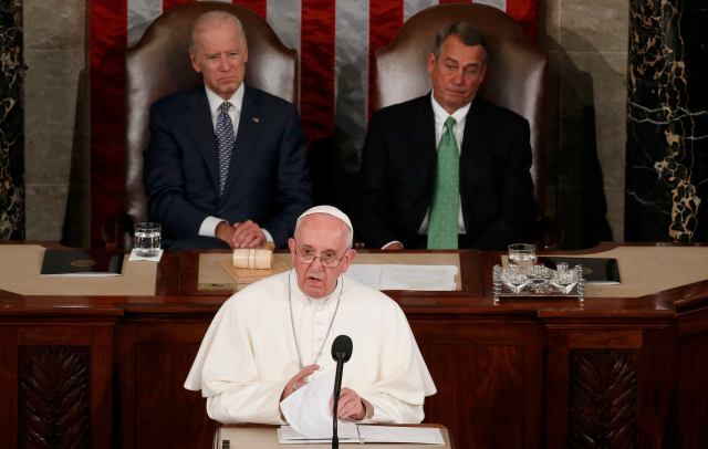 Pope Francis addresses a joint meeting of the U.S. Congress as Vice President Joe Biden (L) and Speaker of the House John Boehner (R) look on in the House of Representatives Chamber on Capitol Hill in Washington September 24, 2015. REUTERS/Jim Bourg