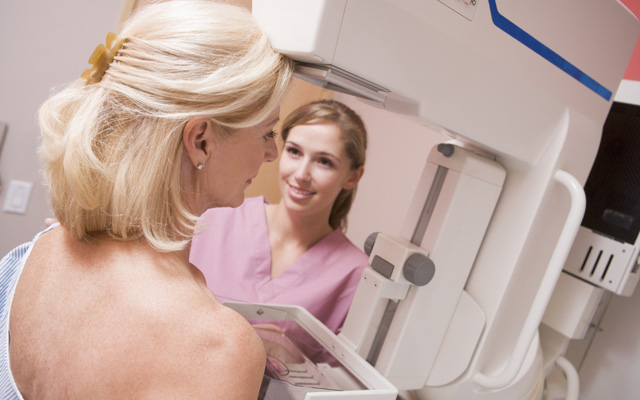 Nurse Assisting Patient Undergoing Mammogram