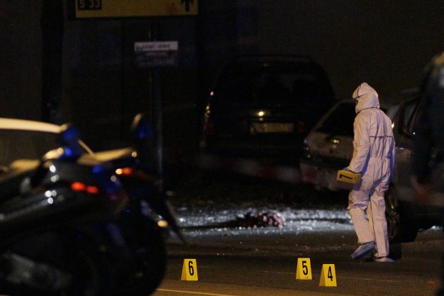 Members of a forensics team work behind a police cordon at the scene of an attack near the Stade de France in Saint Denis, suburban Paris on November 13, 2015.   French President Francois Hollande said Friday he had declared a state of emergency across the country after simultaneous attacks in Paris left at least 39 people dead.   AFP PHOTO / MATTHIEU ALEXANDRE