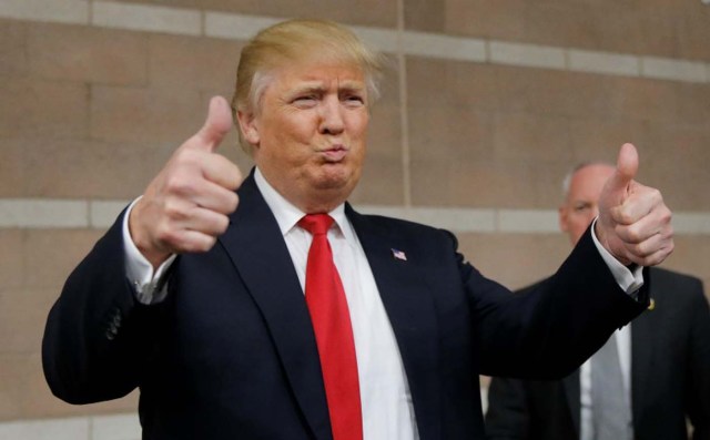 Republican U.S. presidential candidate Trump gives thumbs up to caucus goers as he visits a Nevada Republican caucus site at Palo Verde High School in Las Vegas, Nevada