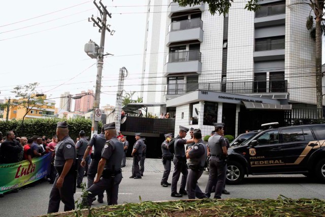 GRA205 SAO PAULO (BRASIL), 04/03/2016.- Agentes de Policía y ciudadanos con pancartas ante la residencia de Lula en la ciudad de Sao Bernardo do Campo, en la periferia de Sao Paulo. La Policía Federal brasileña detuvo hoy al expresidente Luiz Inácio Lula da Silva en el marco de la operación que investiga la red de corrupción en la petrolera estatal Petrobras, según medios locales, aunque no se ha confirmado oficialmente. EFE/SEBASTIÃO MOREIRA