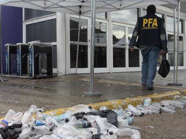 A policeman enters the Costa Salguero event venue in Buenos Aires, Argentina where five young people died of severe intoxication and others were hospitalized in critical condition during the Time Warp electronic music festival on April 16, 2016. / AFP PHOTO / Juan Mabromata