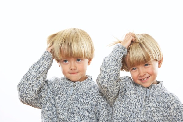 Twin brothers (3-5) pulling hair, close-up