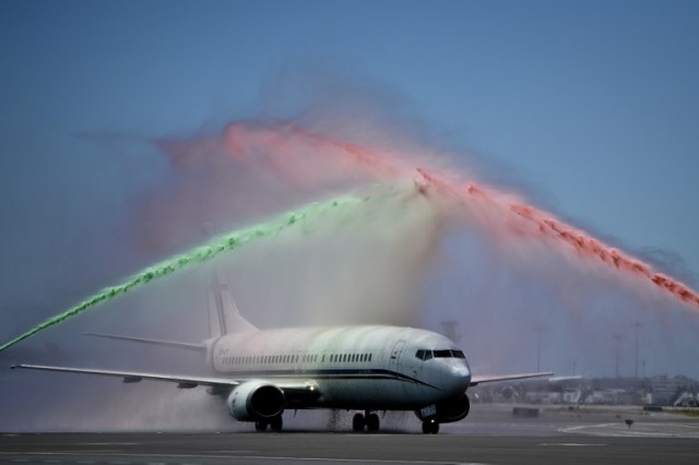 An airport firefighter's unit spray water in the national colours over the aircraft carrying Portugal's national football team members during a welome at Lisbon airport on July 11, 2016 after the Euro 2016 final football win over France yesterday. The Portuguese football team led by Cristiano Ronaldo returned home to a heroes' welcome today after their upset 1-0 win triumph over France in the Euro 2016 final. / AFP PHOTO / PATRICIA DE MELO MOREIRA