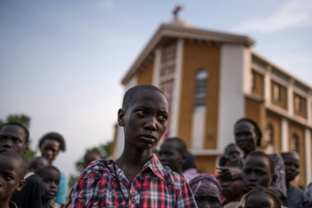 Steven, a young orphaned boy from the recent fighting in Juba who has lost his family from the fighting in Munuki stands on July 12, 2016 in Juba . Many people have fled their homes after heavy fighting started in Juba, and spread to some residential areas in the capital of South Sudan on the eve of independence. Fighting resumed the day after independence and the numbers of casualties are reported to be in the hundreds. A cease fire was declared on the 11th by the President of South Sudan, Salva Kiir Mayardit, and the First Vice President Dr. Riek Machar also reciprocated and declared a ceasefire. / AFP PHOTO / Charles Atiki Lomodong