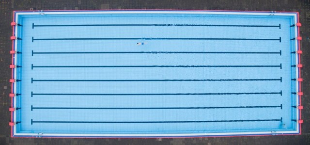 A single visitor swims in the Volksbad Limmer public open air pool in Hanover, central Germany, on July 15, 2016, where sky was cloudy and temperatures were around 15 degrees Celsius. / AFP PHOTO / dpa / Julian Stratenschulte / Germany OUT