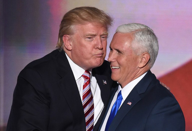 US Republican presidential candidate Donald Trump greets vice presidential candidate Mike Pence after his speech on day three of the Republican National Convention at the Quicken Loans Arena in Cleveland, Ohio, on July 20, 2016.  / AFP PHOTO / TIMOTHY A. CLARY