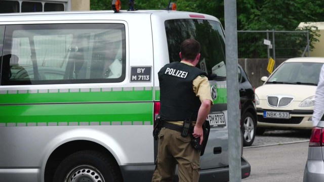 A screen grab taken from video footage shows police officers taking cover at the scene of a shooting rampage at the Olympia shopping mall in Munich, Germany July 22, 2016. dedinac/Marc Mueller/ handout via REUTERS NO ARCHIVES. FOR EDITORIAL USE ONLY. NOT FOR SALE FOR MARKETING OR ADVERTISING CAMPAIGNS. THIS IMAGE HAS BEEN SUPPLIED BY A THIRD PARTY. IT IS DISTRIBUTED, EXACTLY AS RECEIVED BY REUTERS, AS A SERVICE TO CLIENTS.