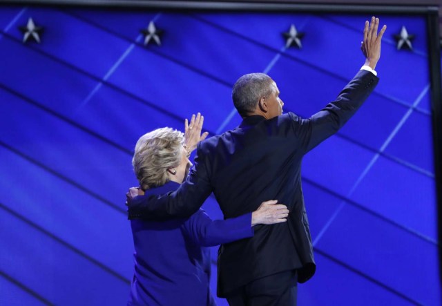 U.S. President Barack Obama and Democratic presidential nominee Hillary Clinton walk off together after appearing onstage after Obama's speech on the third night at the Democratic National Convention in Philadelphia, Pennsylvania, U.S. July 27, 2016. REUTERS/Mark Kauzlarich
