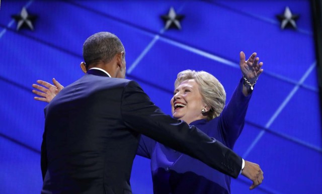 Democratic presidential nominee Hillary Clinton greets U.S. President Barack Obama as she arrives onstage at the end of his speech on the third night of the 2016 Democratic National Convention in Philadelphia, Pennsylvania, U.S., July 27, 2016. REUTERS/Jim Young