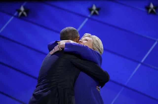 Democratic presidential nominee Hillary Clinton hugs U.S. President Barack Obama as she arrives onstage at the end of his speech on the the third night of the 2016 Democratic National Convention in Philadelphia, Pennsylvania, U.S., July 27, 2016. REUTERS/Jim Young