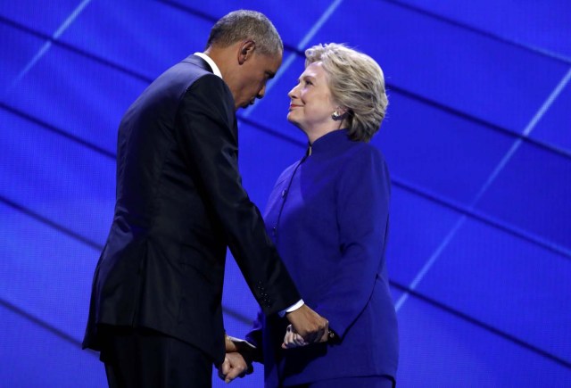 Democratic presidential nominee Hillary Clinton greets U.S. President Barack Obama as she arrives onstage at the end of his speech on the third night of the 2016 Democratic National Convention in Philadelphia, Pennsylvania, U.S., July 27, 2016. REUTERS/Jim Young