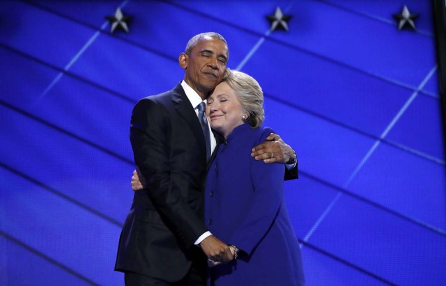 Democratic presidential nominee Hillary Clinton hugs U.S. President Barack Obama as she arrives onstage at the end of his speech on the third night of the 2016 Democratic National Convention in Philadelphia, Pennsylvania, U.S., July 27, 2016. REUTERS/Jim Young TPX IMAGES OF THE DAY