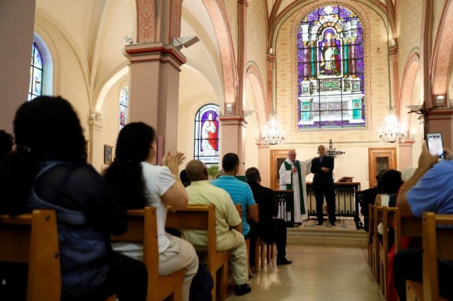 Bagnolet's priest Patrick Morvan (L) holds the shoulder of Bagnolet's Mosque's rector Mohamed Rakkaby (R) as he pronounces a speech to Christian and Muslim believers during a Mass in tribute to priest Jacques Hamel at the Saint-Leu ? Saint-Gilles Bagnolet's Church, near Paris, on July 31, 2016. Muslims across France were invited to participate in Catholic ceremonies today to mourn a priest whose murder by jihadist teenagers sparked fears of religious tension. Masses will be celebrated across the country in honour of octogenarian Father Jacques Hamel, whose throat was cut in his church on July 26, 2016 in the latest jihadist attack on France. / AFP PHOTO / Thomas SAMSON