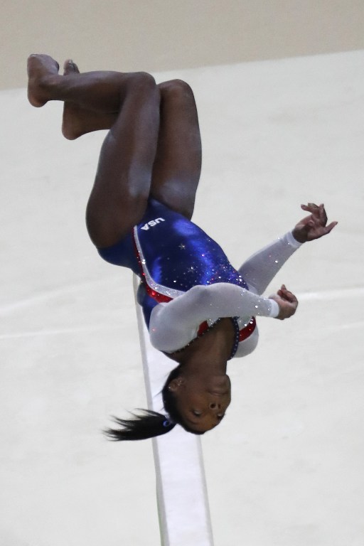 US gymnast Simone Biles competes in the beam event of the women's individual all-around final of the Artistic Gymnastics at the Olympic Arena during the Rio 2016 Olympic Games in Rio de Janeiro on August 11, 2016. / AFP PHOTO / Thomas COEX