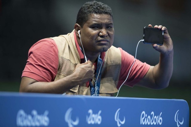 Blind Brazilian photographer Joao Maia takes pictures with his smartphone using the sound as a reference during the Rio 2016 Paralympic Games in Rio de Janeiro, Brazil on September 9, 2016. 41-year-old Maia lost his sight at age 28 due to an affection of the uvea. This is the first sportive event y covers as a photographer. / AFP PHOTO / CHRISTOPHE SIMON