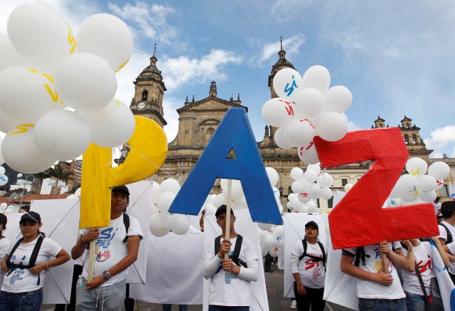 People form the word Peace with letters at the Bolivar square outside the cathedral in Bogota