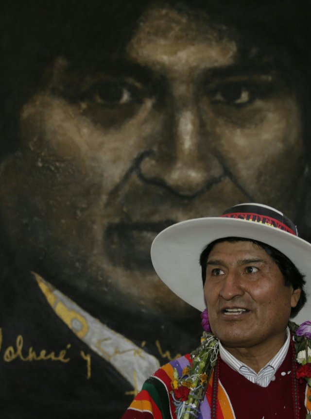 Bolivia's President Evo Morales poses in front of a painting of himself after the inauguration of the Orinoca Museum in Orinoca