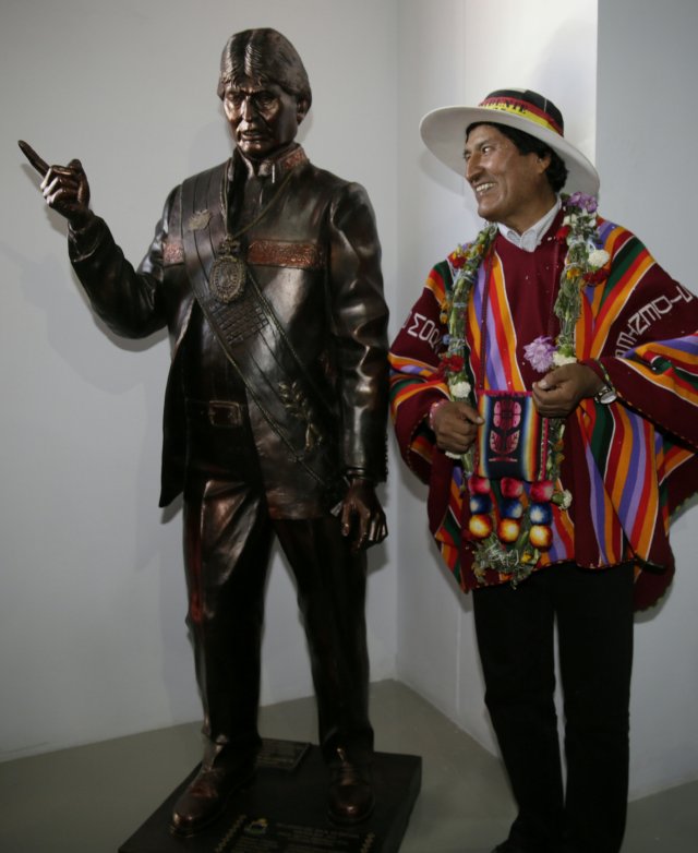 Bolivia's President Evo Morales poses with a statue of himself after the inauguration of the Orinoca Museum in Orinoca