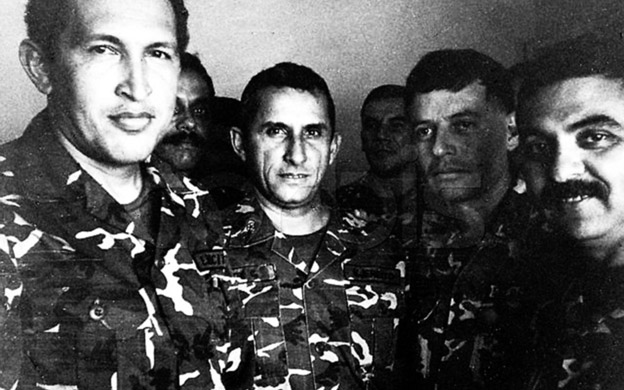 Venezuelan President Hugo Chavez (L) is shown in a 1992 file photo in jail after being arrested for a coup attempt. He stands next to Francisco Arias (2nd R), who is currently running for president, and former police chief Jesus Urdanetta (back center). According to some military insiders, Chavez, the strong favorite to win the July 30 vote, has upset many within the armed forces with his leftist rhetoric, populist policies and meddling in the military's affairs.   REUTERS/str/File photo REUTERS --- Image by © Reuters/CORBIS