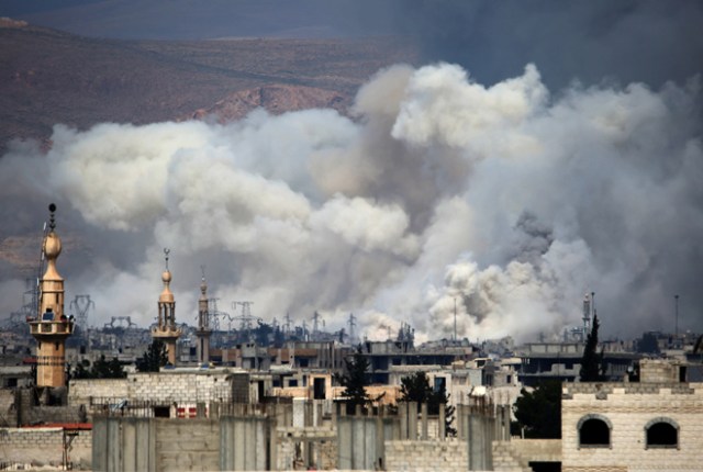 Smoke billows following reported air strikes by Syrian government forces on Damascus' north eastern rebel-held al-Qaboun surburb on March 15, 2017. / AFP PHOTO / AMER ALMOHIBANY