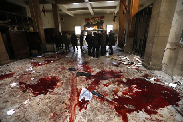 Syrian security forces inspect the scene of a reported suicide bombing at the old palace of justice building in Damascus on March 15, 2017. Two suicide bombings hit Damascus including the attack at the central courthouse that left at least 32 dead, as Syria's war entered its seventh year with the regime now claiming the upper hand. / AFP PHOTO / Louai Beshara