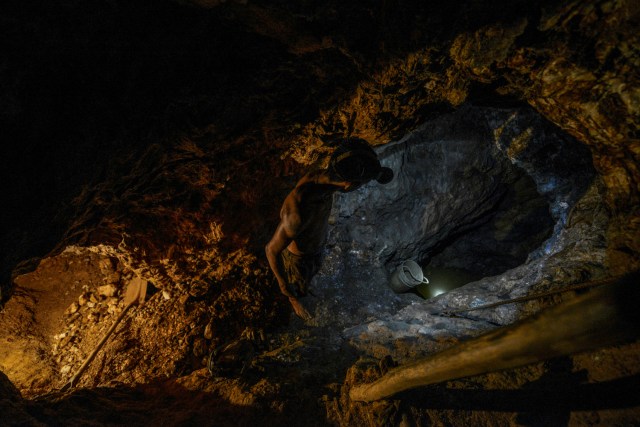 Ender Moreno looks for gold at La Culebra gold mine in El Callao, Bolivar state, southeastern Venezuela on March 1, 2017. Although life in the mines of eastern Venezuela is hard and dangerous, tens of thousands from all over the country head for the mines daily in overcrowded trucks, pushed by the rise in gold prices and by the severe economic crisis affecting the country, aggravated recently by the drop in oil prices. / AFP PHOTO / JUAN BARRETO / TO GO WITH AFP STORY by Maria Isabel SANCHEZ