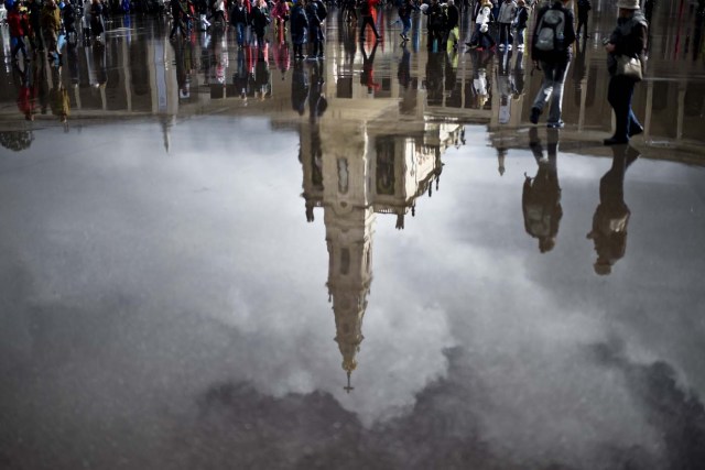 "Nossa Senhora do Rosario de Fatima" Basilica is reflected on the wet pavement in Fatima, central Portugal, on May 12, 2017. Two of the three child shepherds who reported apparitions of the Virgin Mary in Fatima, Portugal, one century ago, will be declared saints on May 13, 2017 by Pope Francis. The canonisation of Jacinta and Francisco Marto will take place during the Argentinian pontiff's visit to a Catholic shrine visited by millions of pilgrims every year. / AFP PHOTO / PATRICIA DE MELO MOREIRA