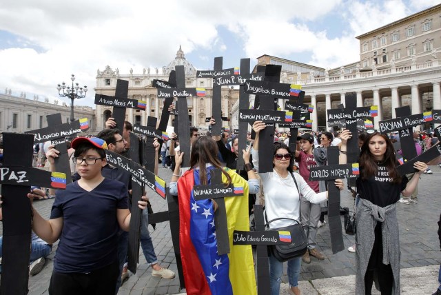 The faithful from Venezuela hold crosses with names of people who died during protests in Venezuela, before the Regina Coeli prayer led by Pope Francis in Saint Peter's Square at the Vatican May 7, 2017. REUTERSMax Rossi