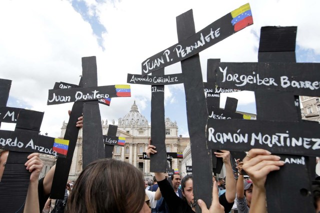 The faithful from Venezuela hold crosses with names of people who died during protests in Venezuela, before the Regina Coeli prayer led by Pope Francis in Saint Peter's Square at the Vatican May 7, 2017. REUTERSMax Rossi