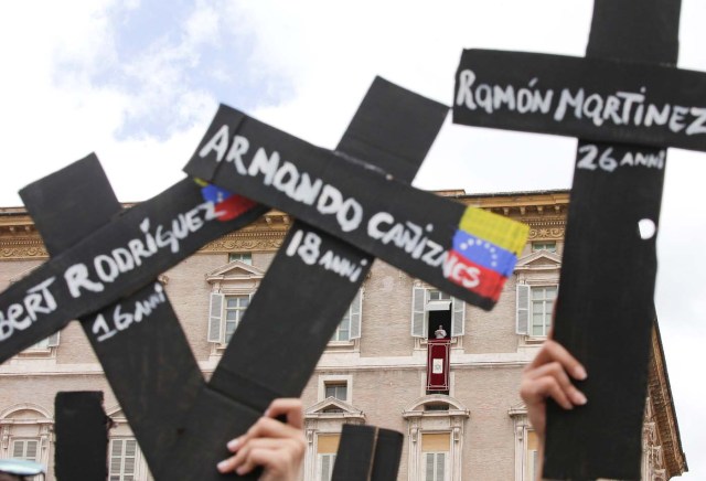 The faithful from Venezuela hold crosses with names of people who died during protests in Venezuela, before the Regina Coeli prayer led by Pope Francis in Saint Peter's Square at the Vatican May 7, 2017. REUTERSMax Rossi