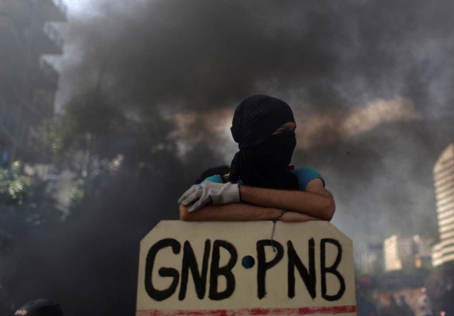 An opposition supporter looks on while clashing with riot security forces during a rally against President Nicolas Maduro in Caracas, Venezuela, May 18, 2017. REUTERS/Marco Bello