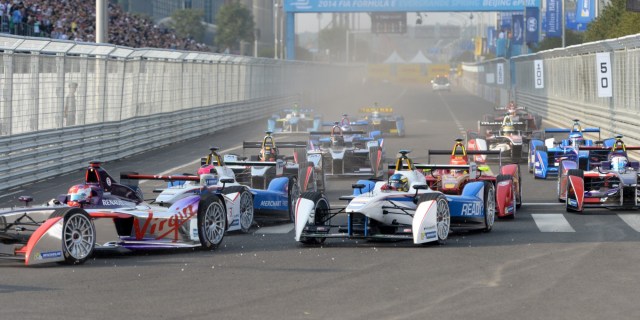 Formula E cars battle for positions at the start of the Formula E race near the Bird's Nest stadium in Beijing on September 13, 2014. AFP PHOTO / GOH CHAI HIN        (Photo credit should read GOH CHAI HIN/AFP/Getty Images)