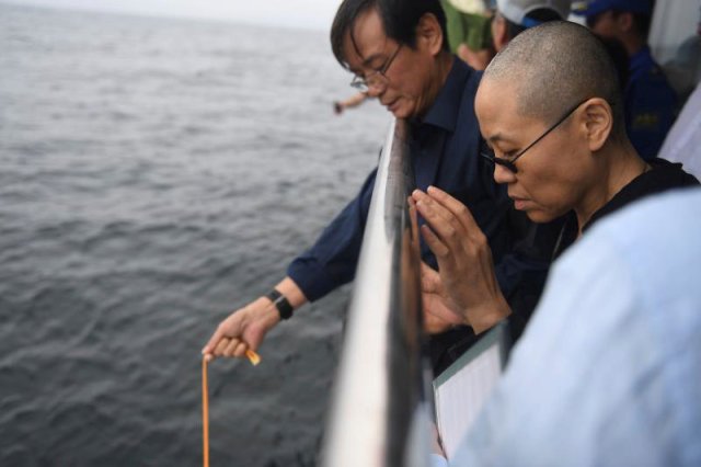 Liu Xia, wife of deceased Chinese Nobel Peace Prize-winning dissident Liu Xiaobo and other relatives attend his sea burial off the coast of Dalian, China in this photo released by Shenyang Municipal Information Office on July 15, 2017. Shenyang Municipal Information Office/via REUTERS ATTENTION EDITORS - THIS IMAGE WAS PROVIDED BY A THIRD PARTY. NO RESALES. NO ARCHIVES.