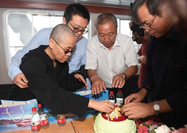 Liu Xia, wife of deceased Chinese Nobel Peace Prize-winning dissident Liu Xiaobo and other relatives attend his sea burial off the coast of Dalian, China in this photo released by Shenyang Municipal Information Office on July 15, 2017. Shenyang Municipal Information Office/via REUTERS ATTENTION EDITORS - THIS IMAGE WAS PROVIDED BY A THIRD PARTY. NO RESALES. NO ARCHIVES.