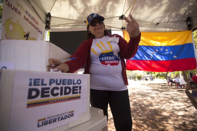 BRA105. BRASILIA (BRASIL), 16/07/2017.- La comunidad venezolana de Brasilia vota en la calle la consulta popular impulsada por los opositores del presidente Nicolás Maduro ante la negativa del Ayuntamiento a que se realizase en un centro cívico por la falta de permisos hoy, domingo 16 de julio de 2017, en Brasilia (Brasil). La oposición venezolana lanza este domingo su mayor desafío al Gobierno del presidente Nicolás Maduro con la convocatoria de una consulta calificada de ilegal desde el oficialismo en la que espera que el pueblo se pronuncie masivamente contra el proceso constituyente impulsado por el chavismo. EFE/Joédson Alves