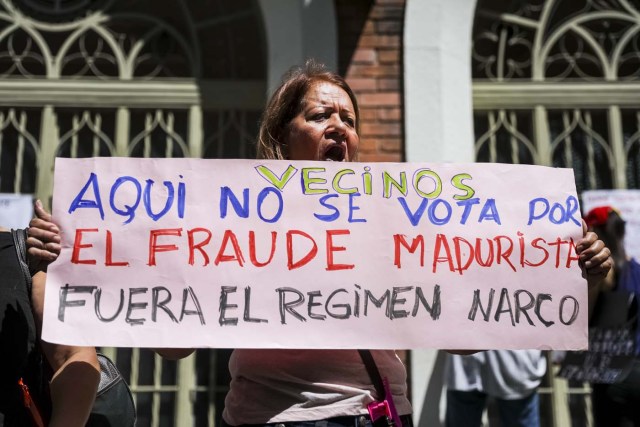 CAR07. CARACAS (VENEZUELA), 24/07/2017.- Una mujer se manifiesta en rechazo a la Asamblea Constituyente hoy, lunes 24 de julio de 2017, en un colegio electoral de Caracas (Venezuela). Venezuela inicia hoy la semana decisiva para la elección de la Asamblea Nacional Constituyente convocada por el presidente, Nicolás Maduro, con los oficialistas entrando en la recta final de su campaña en medio de protestas y llamados a paro de los opositores en rechazo a esos comicios. EFE/Miguel Gutiérrez