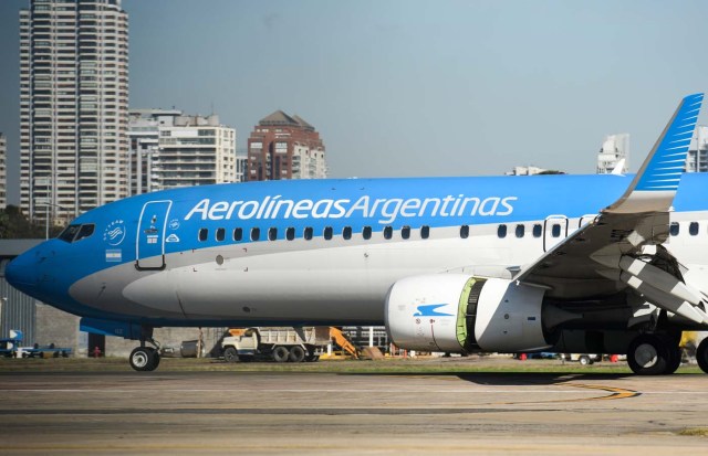 An Aerolineas Argentinas airplane taxis along the runway at the Jorge Newbery Airport in Buenos Aires, on August 2, 2017. Argentine state-run carrier Aerolineas Argentinas cancelled its August 5 weekly flight to Caracas over operational capacity and security concerns, the company said. Several foreign airlines, including Air France, Delta, Avianca and Iberia have also suspended flights to the country over security concerns due to the political situation. / AFP PHOTO / Eitan ABRAMOVICH