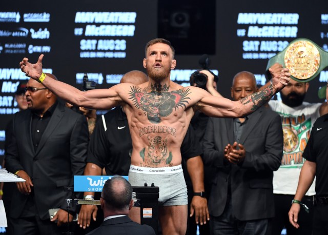 LAS VEGAS, NV - AUGUST 25: UFC lightweight champion Conor McGregor poses on the scale during his official weigh-in at T-Mobile Arena on August 25, 2017 in Las Vegas, Nevada. McGregor will meet boxer Floyd Mayweather Jr. in a super welterweight boxing match at T-Mobile Arena on August 26. Ethan Miller/Getty Images/AFP