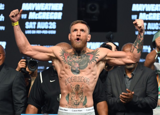 LAS VEGAS, NV - AUGUST 25: UFC lightweight champion Conor McGregor poses on the scale during his official weigh-in at T-Mobile Arena on August 25, 2017 in Las Vegas, Nevada. McGregor will meet boxer Floyd Mayweather Jr. in a super welterweight boxing match at T-Mobile Arena on August 26. Ethan Miller/Getty Images/AFP