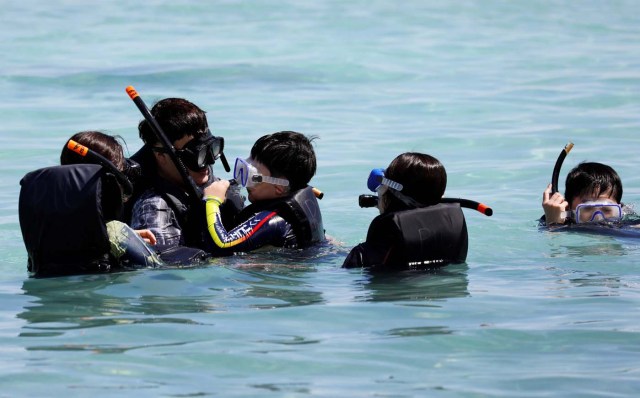 Tourists snorkel on the waters off Tumon beach on the island of Guam, a U.S. Pacific Territory, August 11, 2017. REUTERS/Erik De Castro