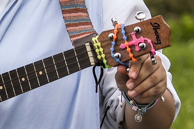 Nun Maria Valentina de los Angeles, of the ?Comunicadoras Eucaristicas del Padre Celestial? (Eucharistic Communicators of the Celestial Father) congregation, tunes a ukulele during the recording of a music video at a convent in the outskirts of Cali, Colombia, on July 17, 2017. Nun Maria Valentina de los Angeles ?who wears tennis shoes, raps and already participated in a reality show- will see her dream of singing to Pope Francis come true during his visit to Colombia. / AFP PHOTO / Luis ROBAYO / TO GO WITH AFP STORY BY RODRIGO ALMONACID