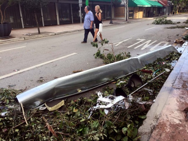 Debris litters a street after the passage of Hurricane Irma on September 11, 2017, in Miami. Irma weakened early Monday to a tropical storm as it continued on a northward path through Florida, the National Hurricane Center said. As of 8 am (1200 GMT), Irma was about 105 miles (170 kilometers) northwest of Tampa, with maximum sustained winds of 70 miles per hour (110 kilometers per hour). Early reports of Irma's aftermath seemed to show that damage in Florida from the massive storm were not as bad as initially feared. / AFP PHOTO / Michele Eve SANDBERG