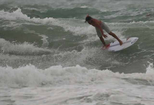 MIAMI BEACH, FL - SEPTEMBER 09: A surfer enjoys the waves churned up buy the approaching Hurricane Irma on September 9, 2017 in Miami Beach, Florida. Florida is in the path of the Hurricane which may come ashore at category 4.   Joe Raedle/Getty Images/AFP