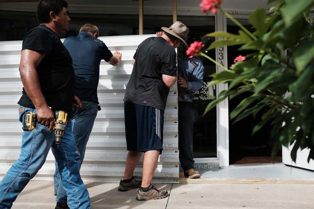 NAPLES, FL - SEPTEMBER 09: Metal siding is placed in front of a business in downtown Naples before the arrival of Hurricane Irma into Southwest Florida on September 9, 2017 in Naples, Florida. The Naples area could begin to feel hurricane-force winds from Irma by 11 a.m. Sunday and experience wind gusts over 100 mph from Sunday through Monday.   Spencer Platt/Getty Images/AFP