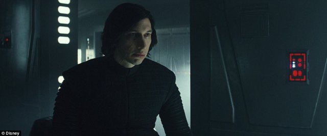 He's still on the dark side_ Brooding, battle weary Kylo Ren (played by Adam Driver) is seen in black looking off in the distance